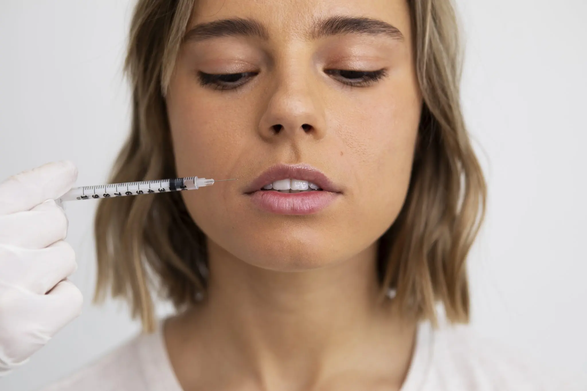 Close-up of a clinician performing an injectable aesthetic procedure